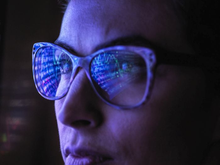 Lady with data reflected in her glasses