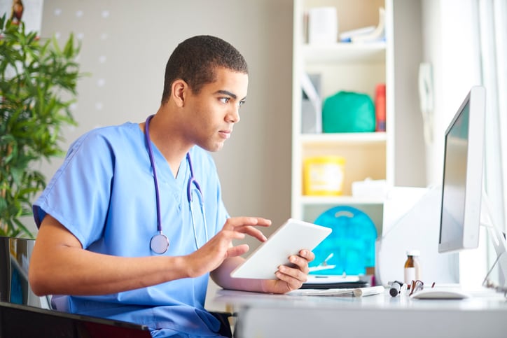 Doctor checking patient notes on computer 