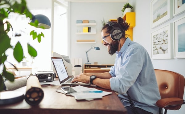 Man wearing headphones working at a computer