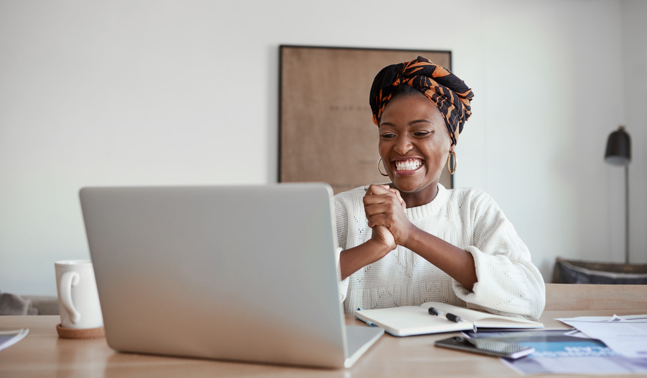 Happy lady sitting behind her laptop