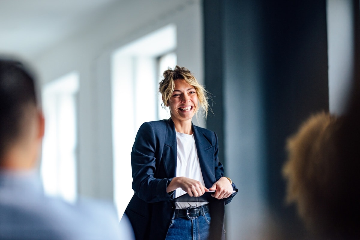 Lady in blue blazer and white t-shirt smiling 