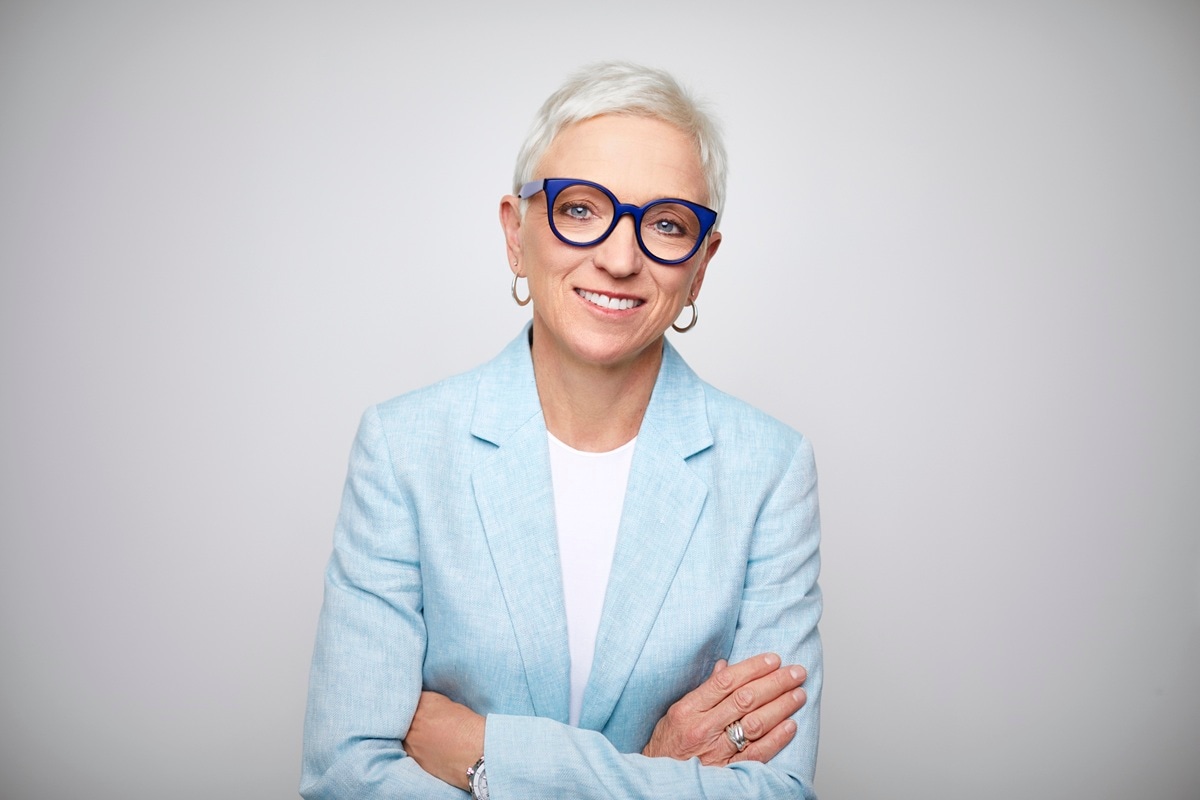 lady with short grey hair and blue glasses