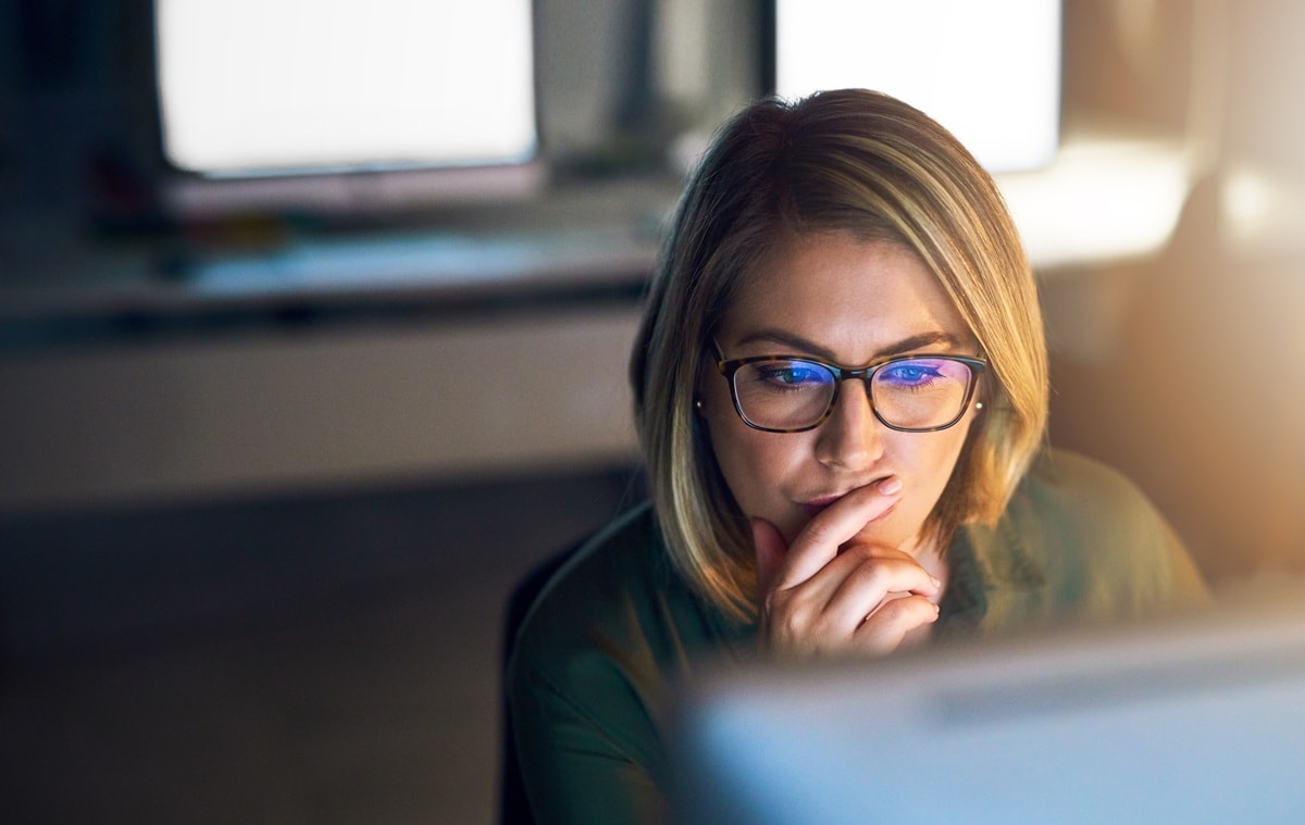 Lady sitting a desk with glasses on