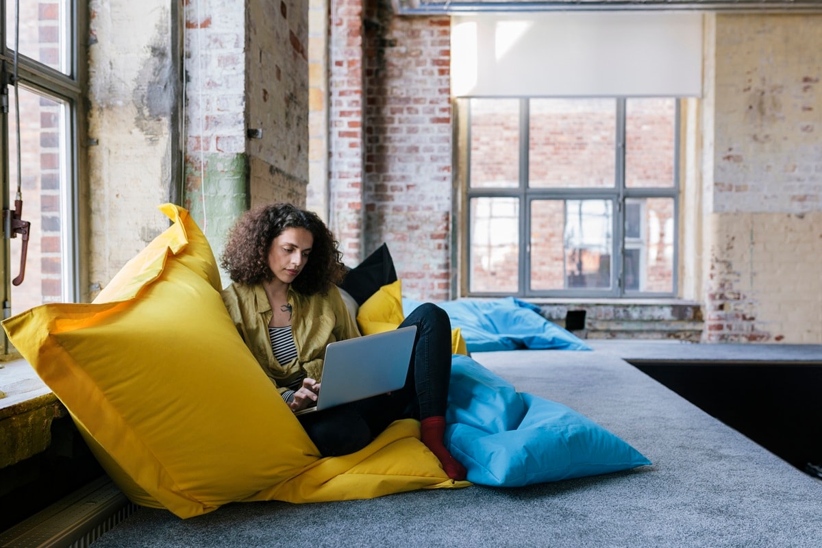 Lady sitting in window with yellow pillow