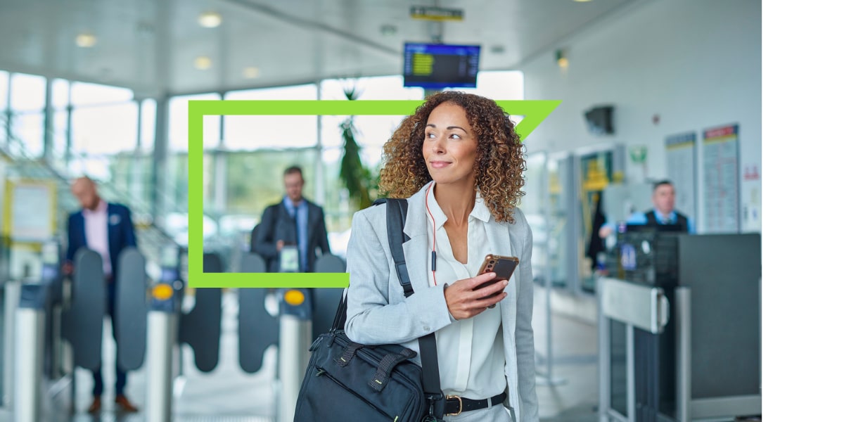 woman in grey jacket with mobile phone at airport