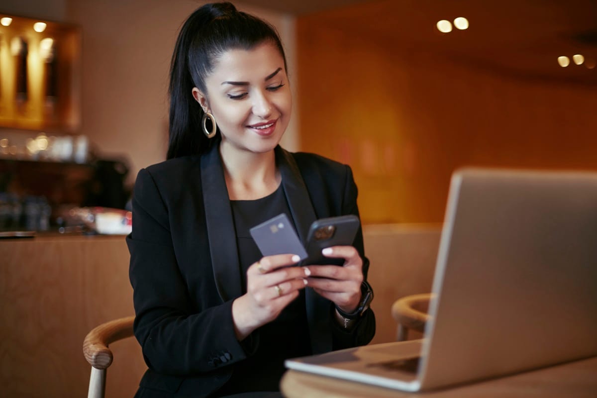 Lady holding phone and credit card