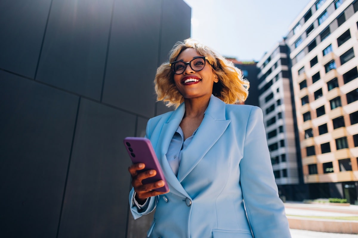 Lady in blue suit walking down road