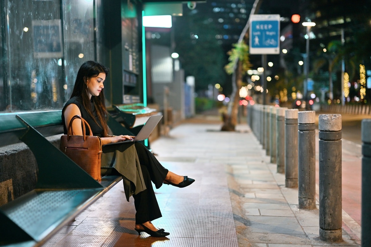 Lady sitting in street with laptop open