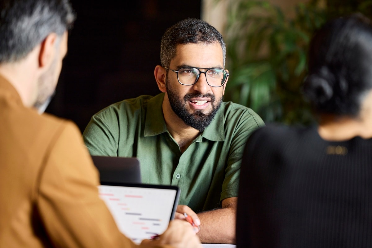 Man in green top and glasses