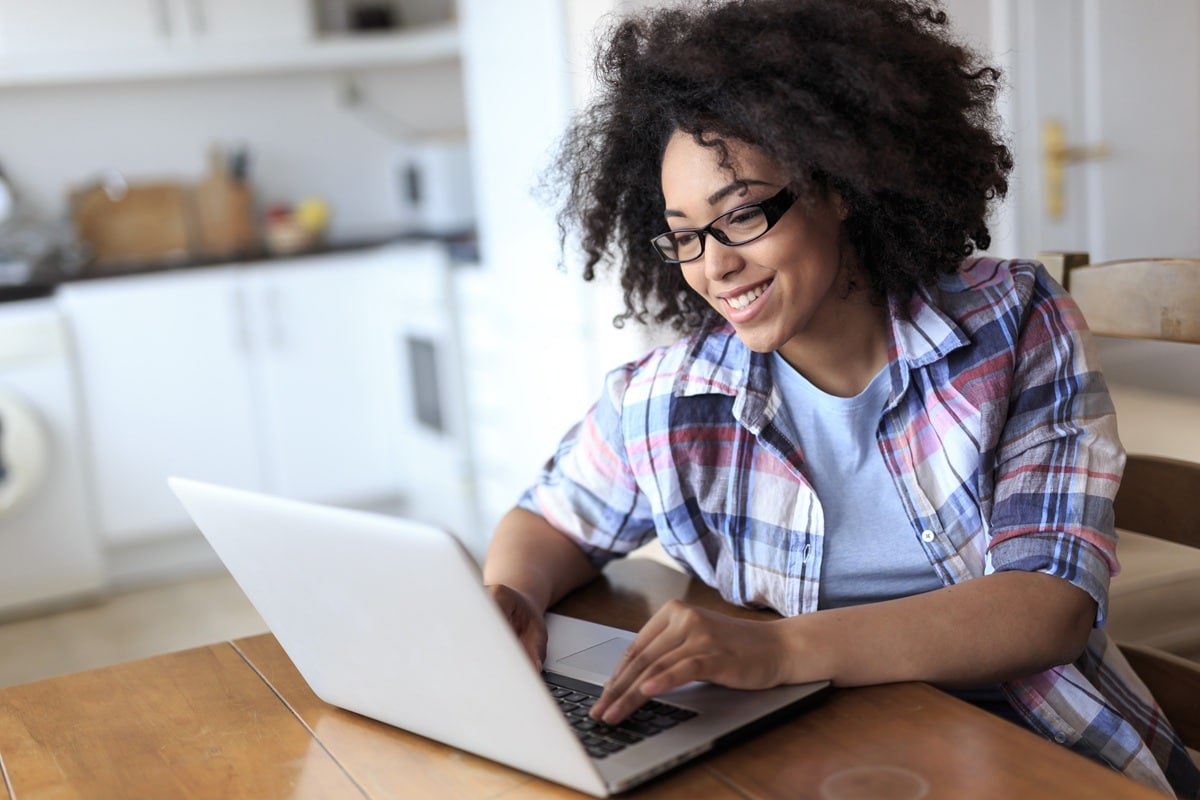 Lady in checked shirt looking at laptop