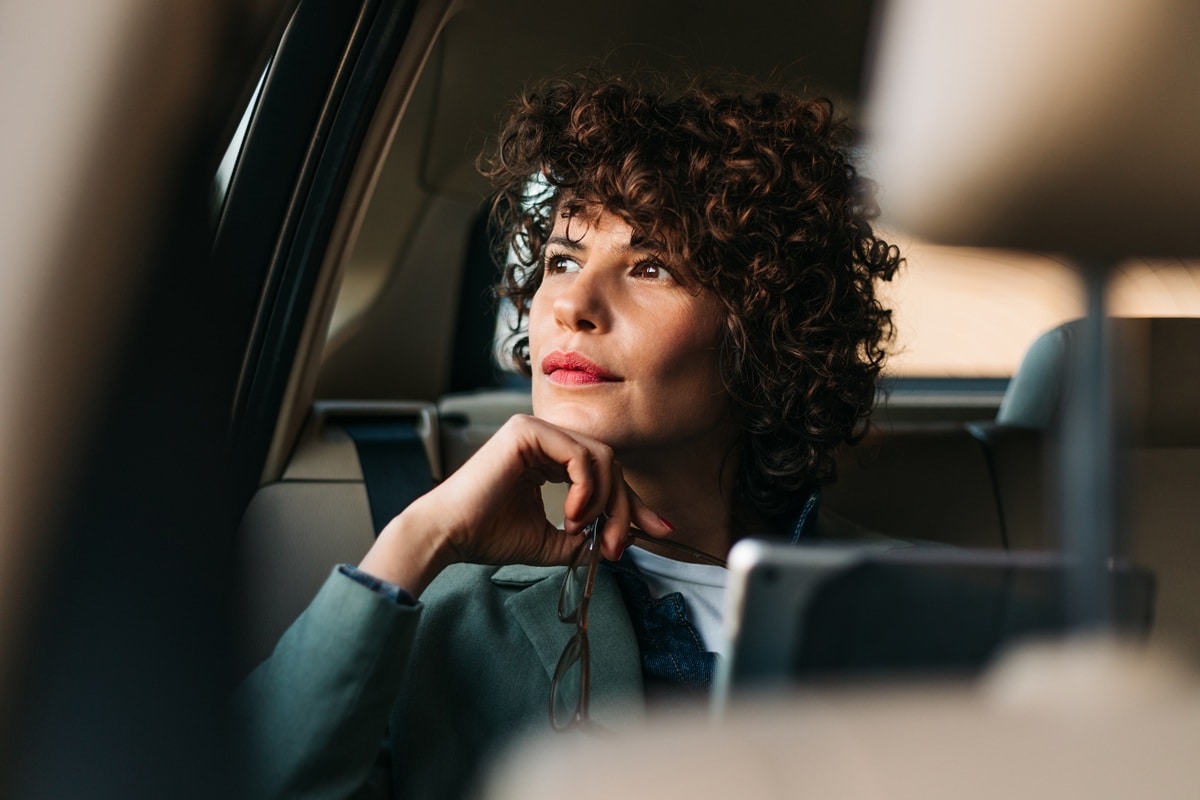 Lady sitting in car looking out of window