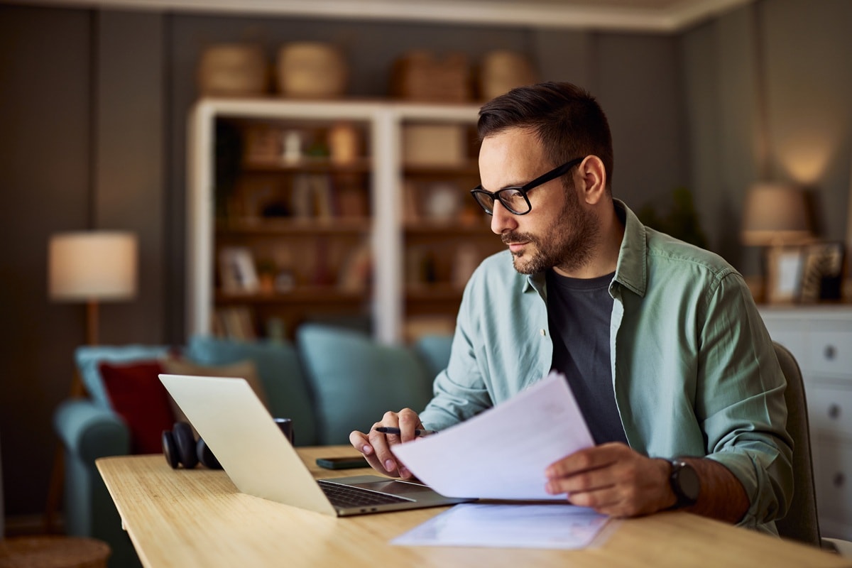 Man working from living room looking at laptop