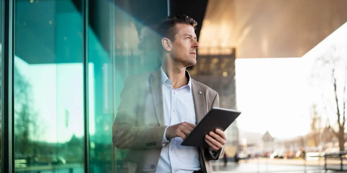 a finance leader holding a tablet 