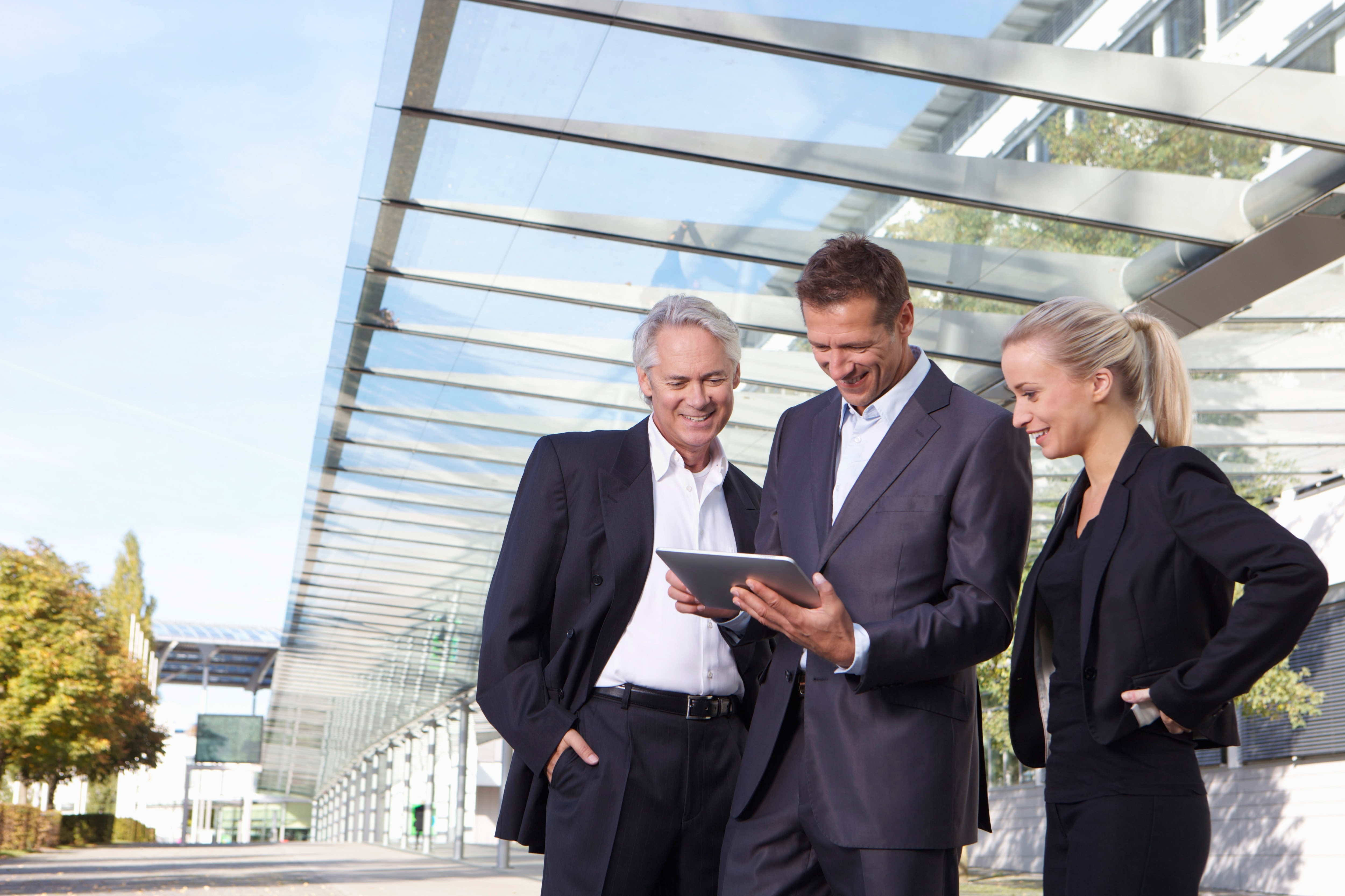 People looking at a tablet 