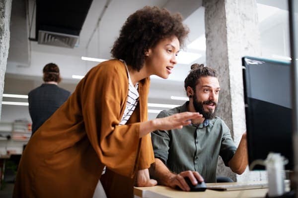 Lady and man looking at computer screen