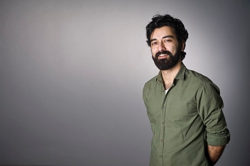 Man in green shirt with black beard 