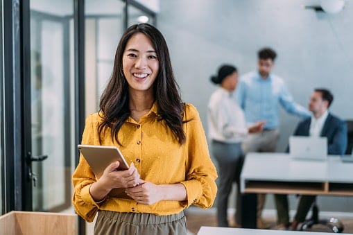 Lady in yellow shirt holding tablet