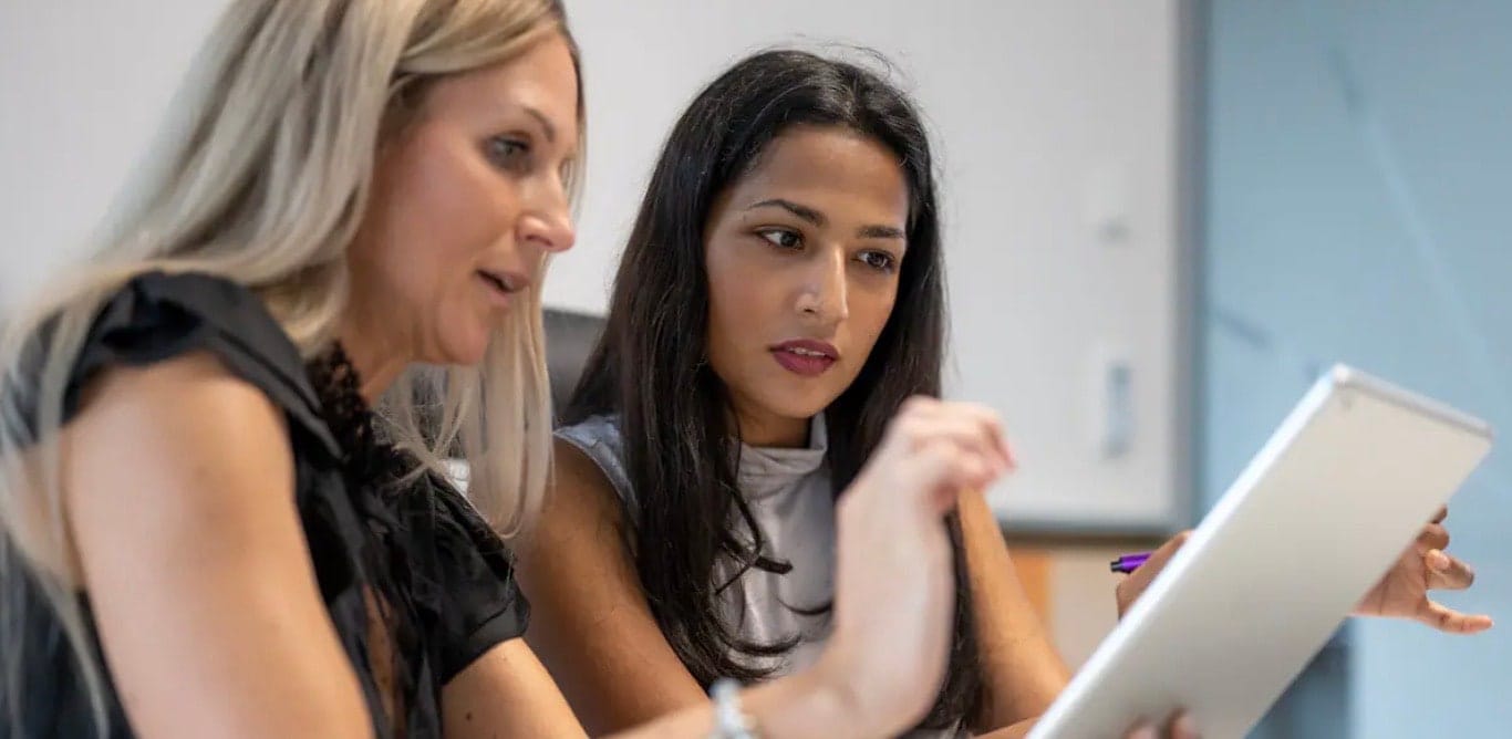 Two employees looking at screen 