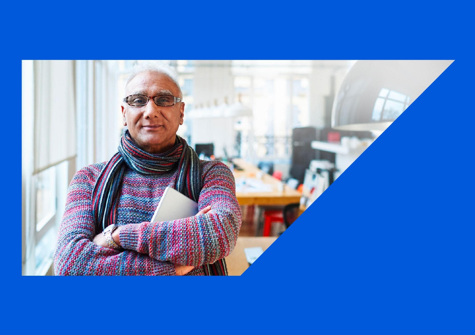 Man with arms folded and laptop 