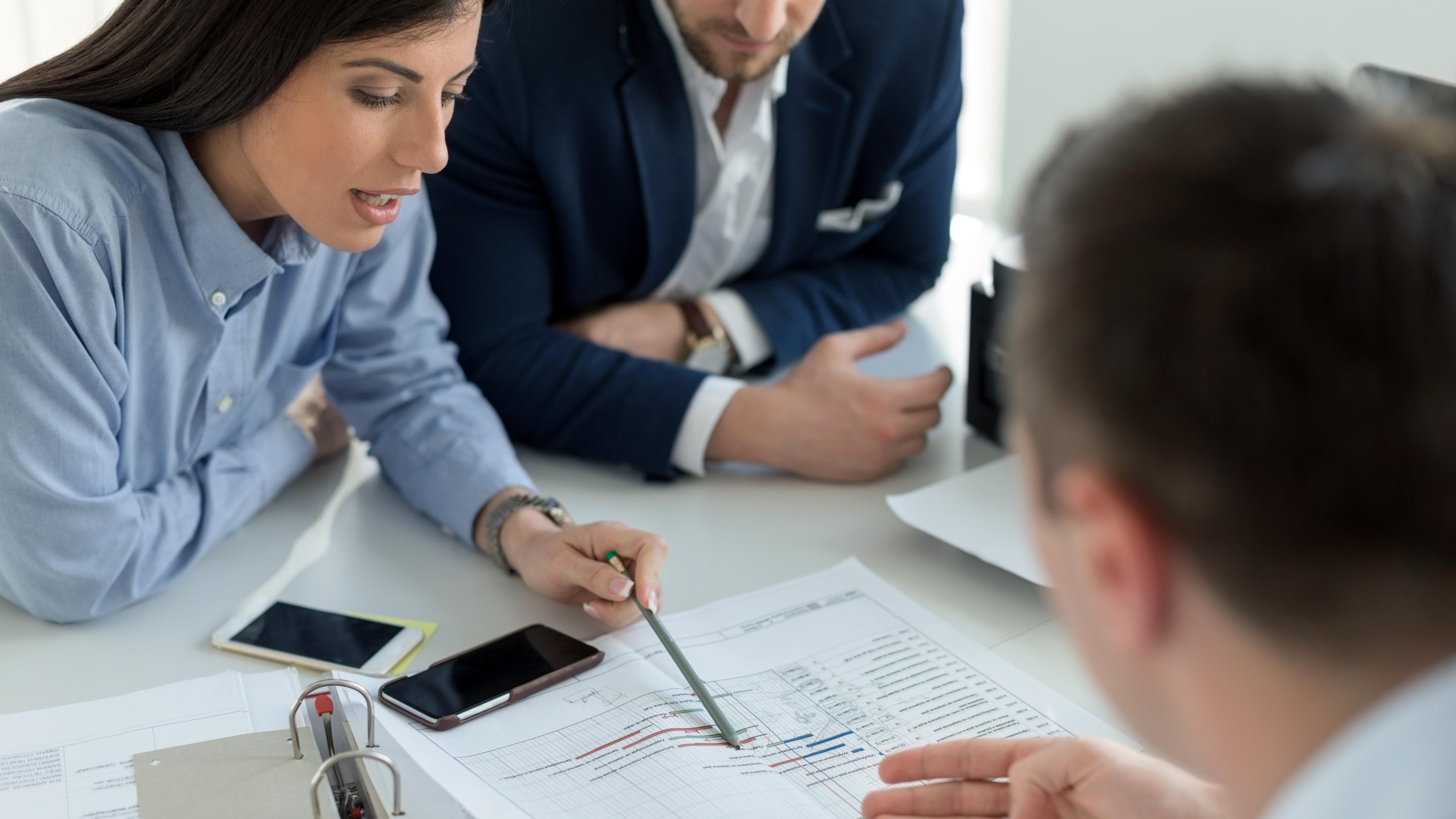 group of people look at papers at work