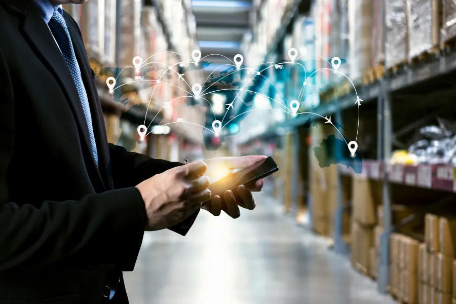 Man with phone in warehouse