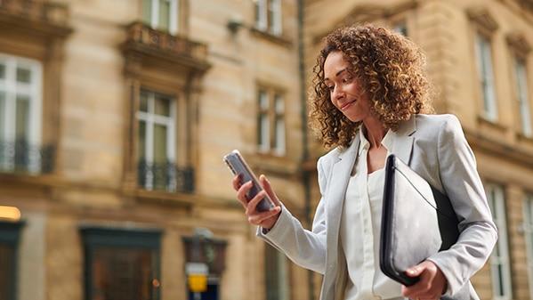 Woman walking while using her phone