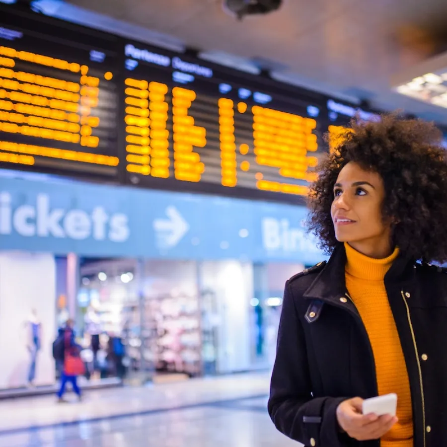 Woman standing at a train station