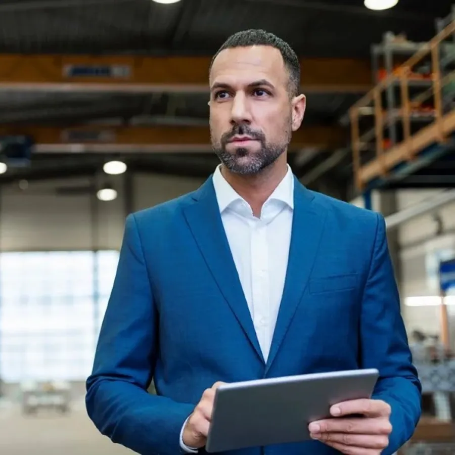 Man holding tablet in manufacturing warehouse